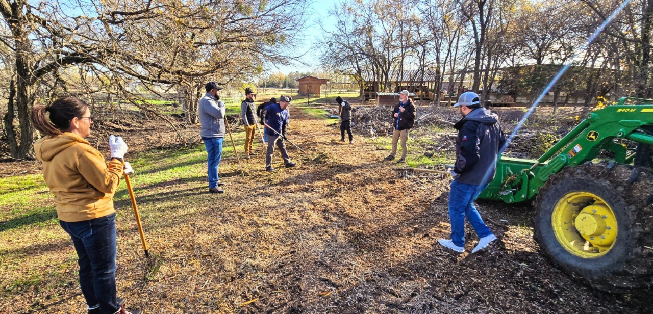 Group of people working on a dirt road at Boton Farms