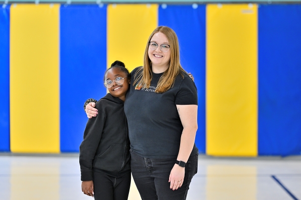 child and woman hugging and smiling, communities in schools of NM