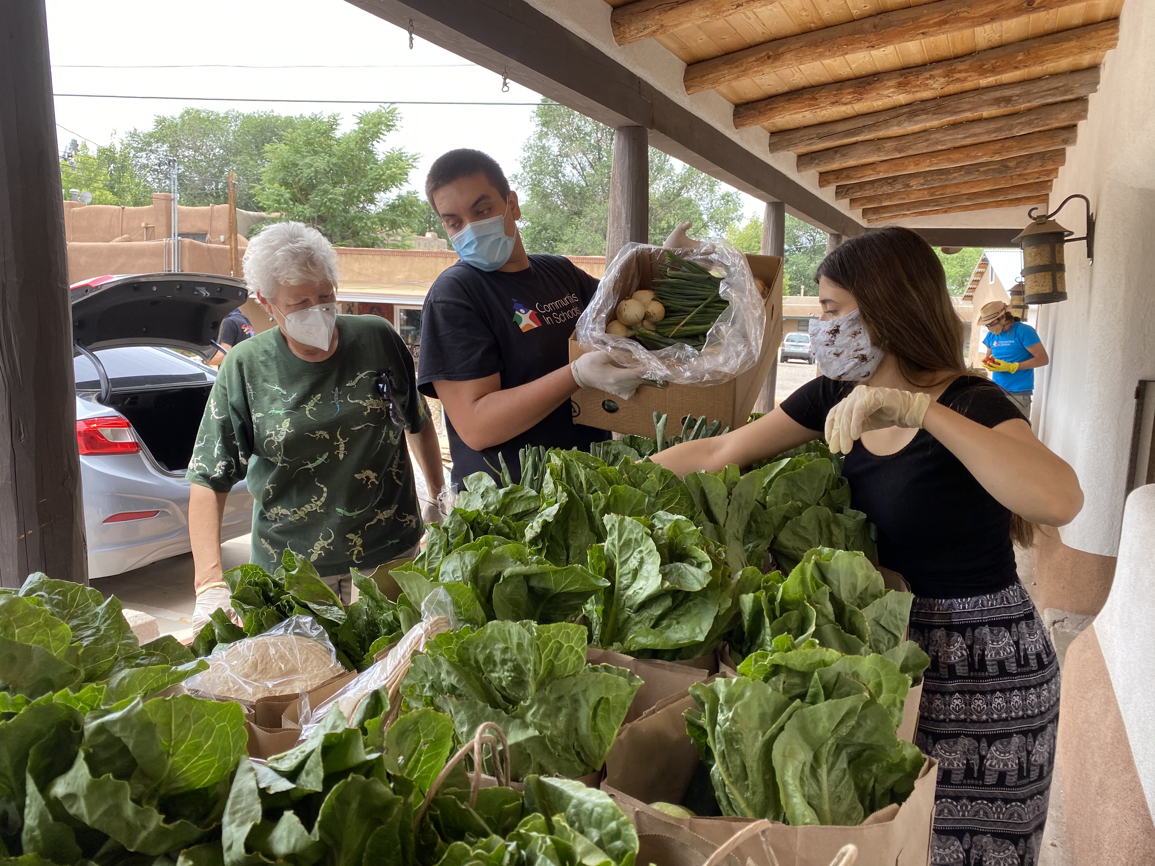 Enterprise Bank & ﻿Trust associates and members from Communities In Schools working together to pack food bags for families of children in public schools facing food insecurity in 2020. (Sante Fe)