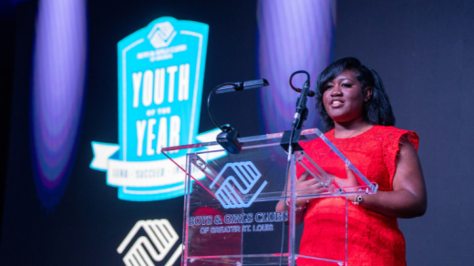 Woman speaking on a stage, Boys and Girls Club of Greater St. Louis
