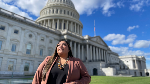 Woman standing in front of a Capital building, 2024 community impact report