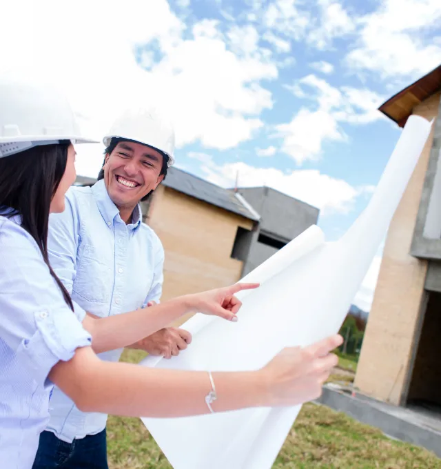 Hispanic couple looking at house plans
