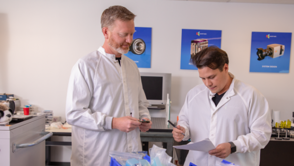 Two men in lab coats looking at data