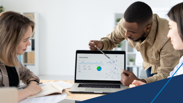 Man showing something on a computer screen to a woman