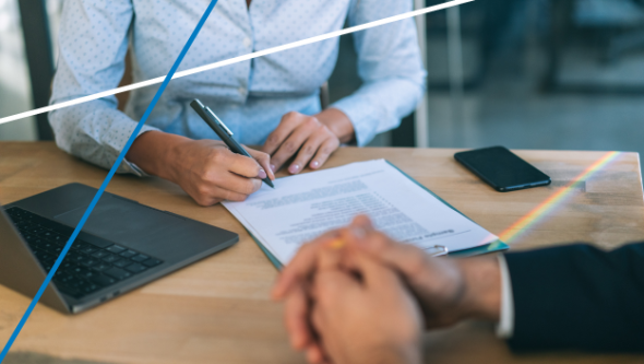 two men at a desk discussing closing business details