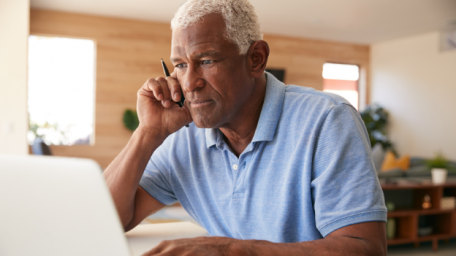 Older man sitting at computer