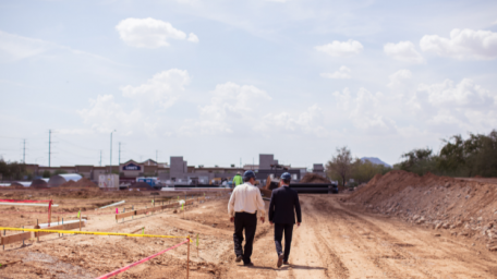 Two men walking in construction site