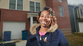 woman standing front of a house, Closing Wealth Gap