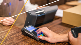 hand on payment processor machine, merchant services, Enterprise Bank & Trust