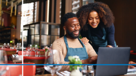 Man and Woman looking at a computer, SBA Loan