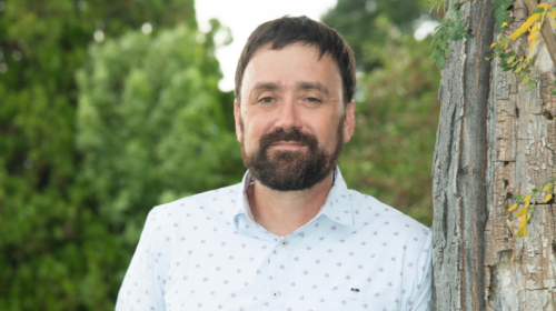 Man with a beard smiling