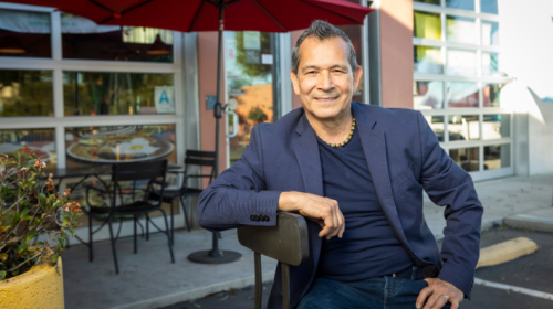 Man sitting in front of a store